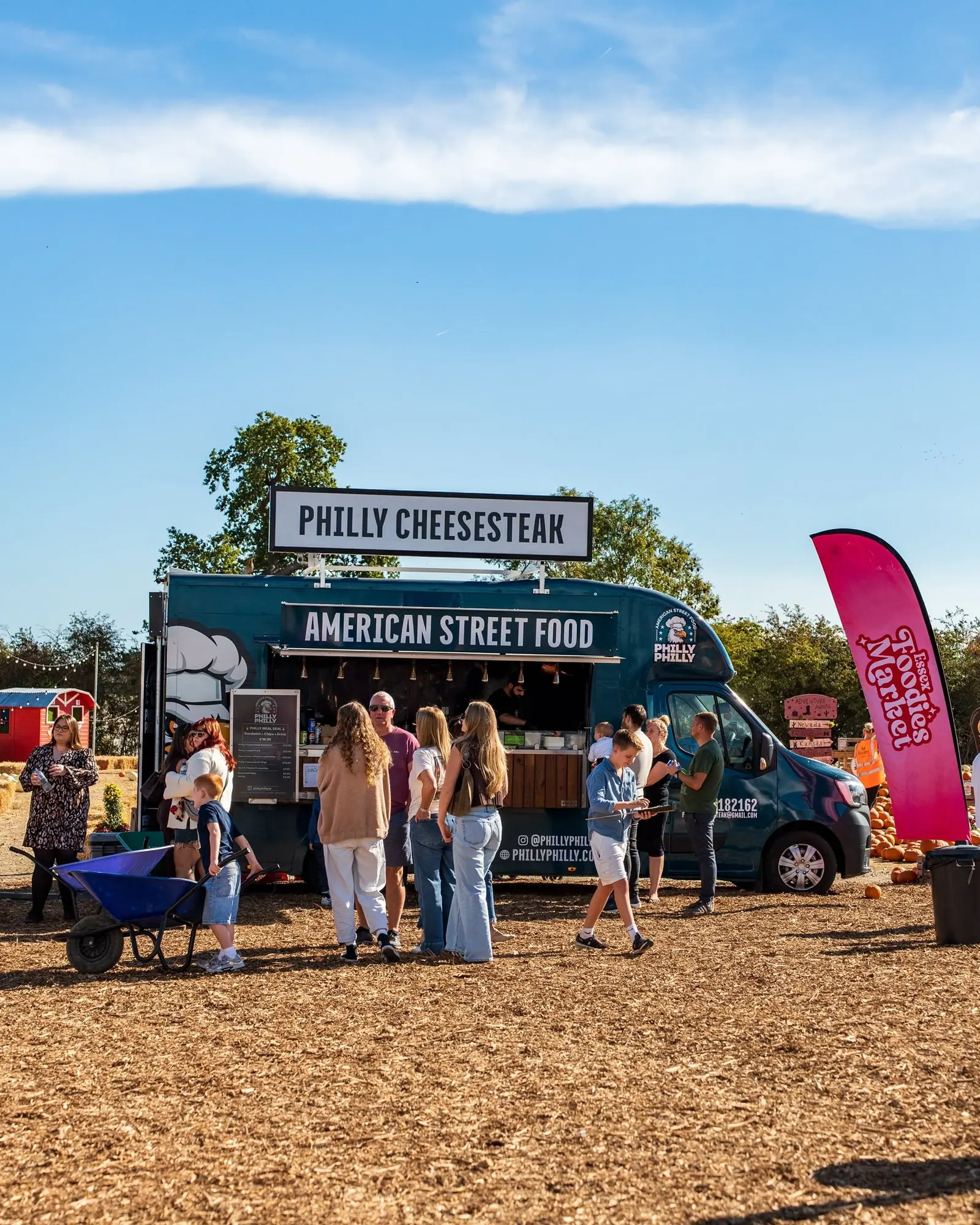 Families queueing at the Philly Philly food truck at an outdoor summer event