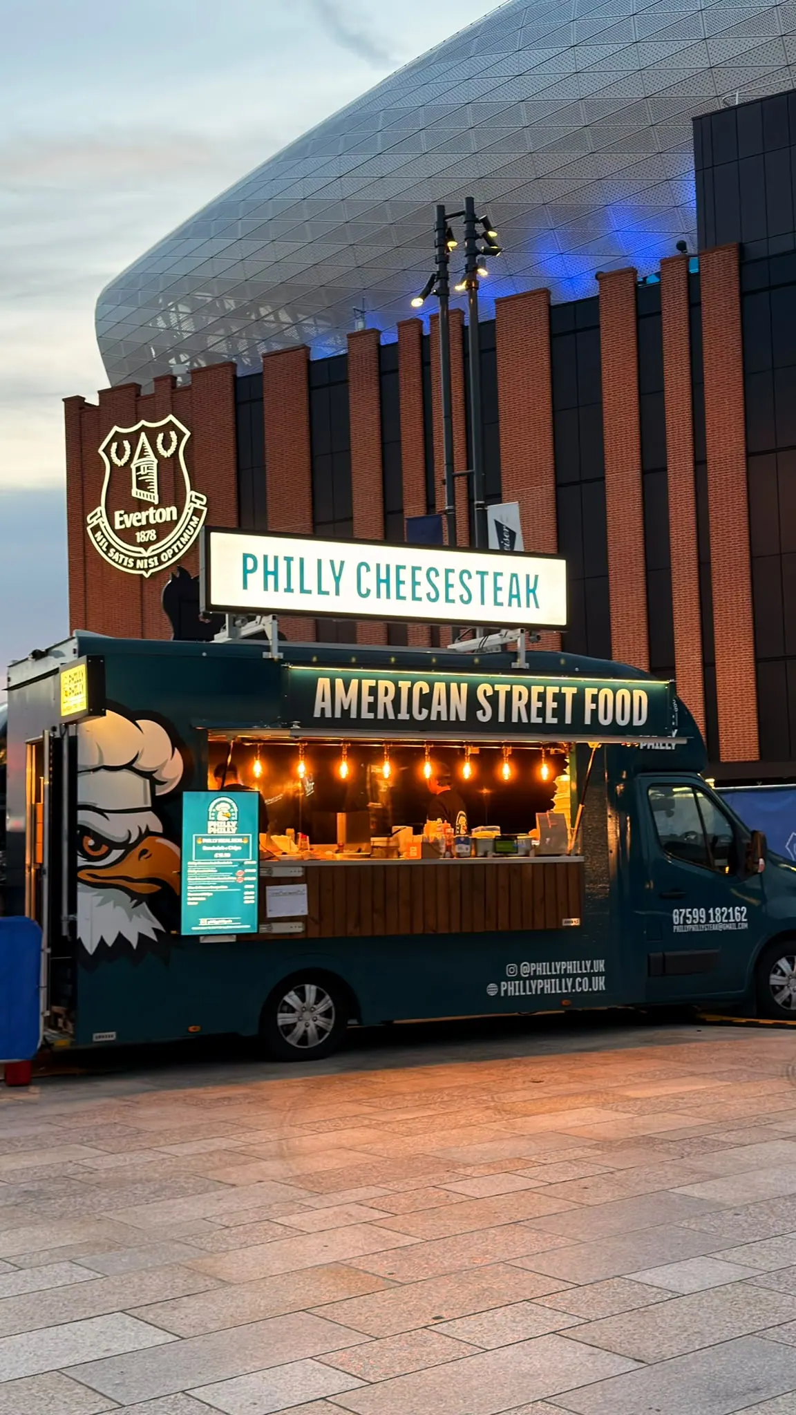 The Philly Philly American street food truck lit up at an evening event