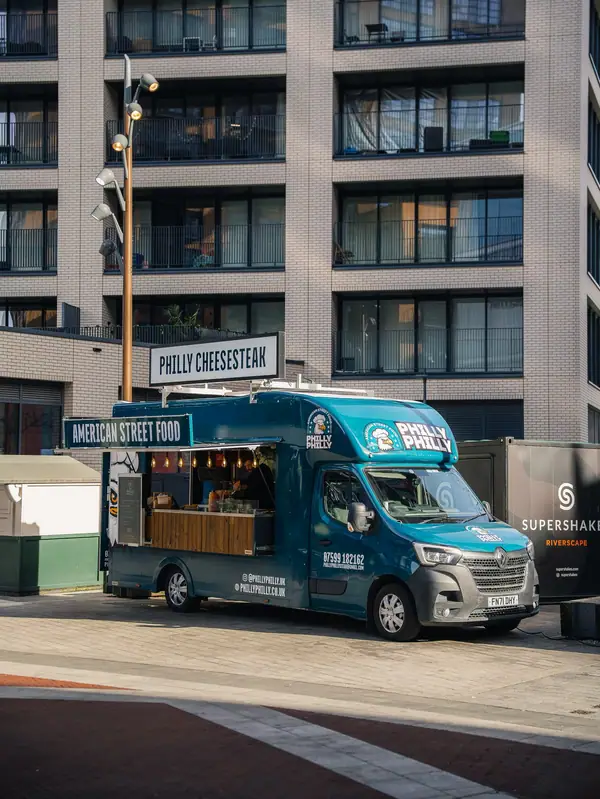 The Philly Philly food truck parked outside a modern office building