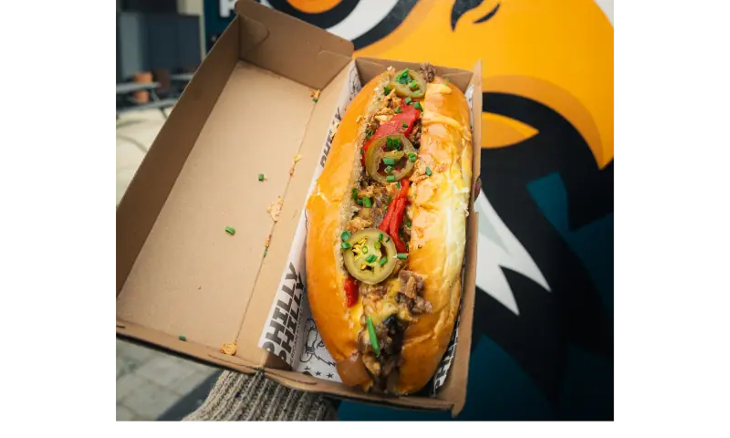 Philly cheesesteak sandwich with melted cheddar